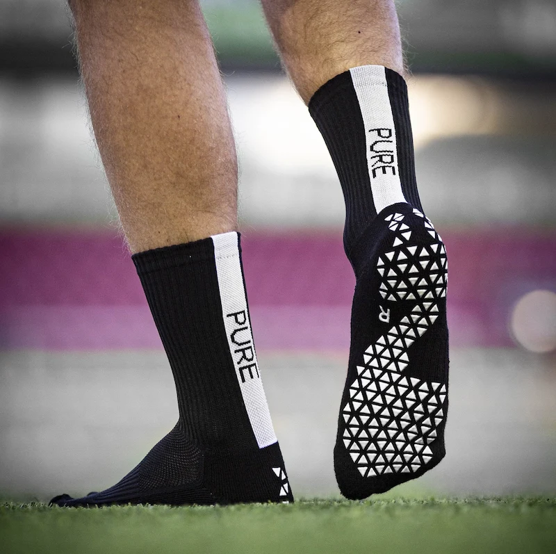 black and white sports socks with geometric pattern on field