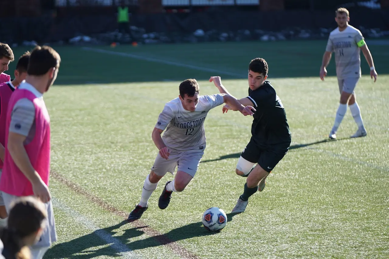 georgetown soccer players battling for ball