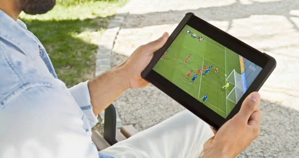 man watching soccer on tablet