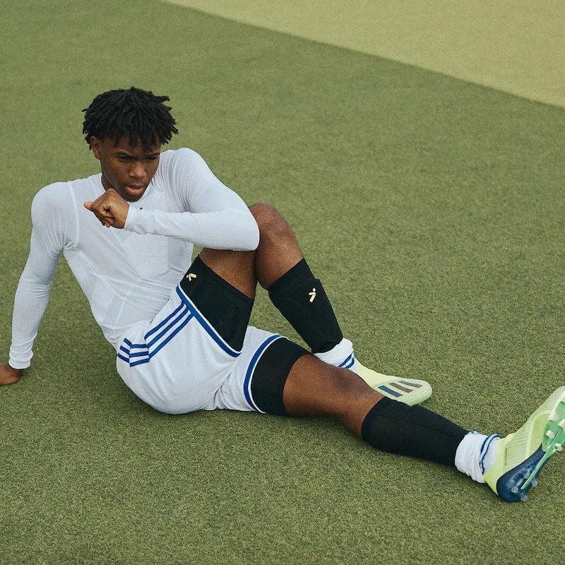 soccer player sitting on field wearing top gear 2023